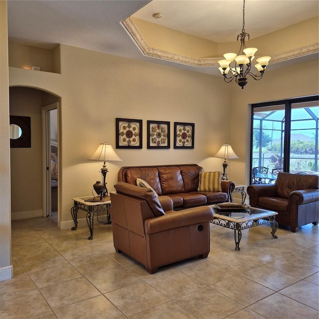 19 Medalist Way, Rotonda West, FL 33947 - living room featuring arched walkways, a chandelier, and light tile patterned floors