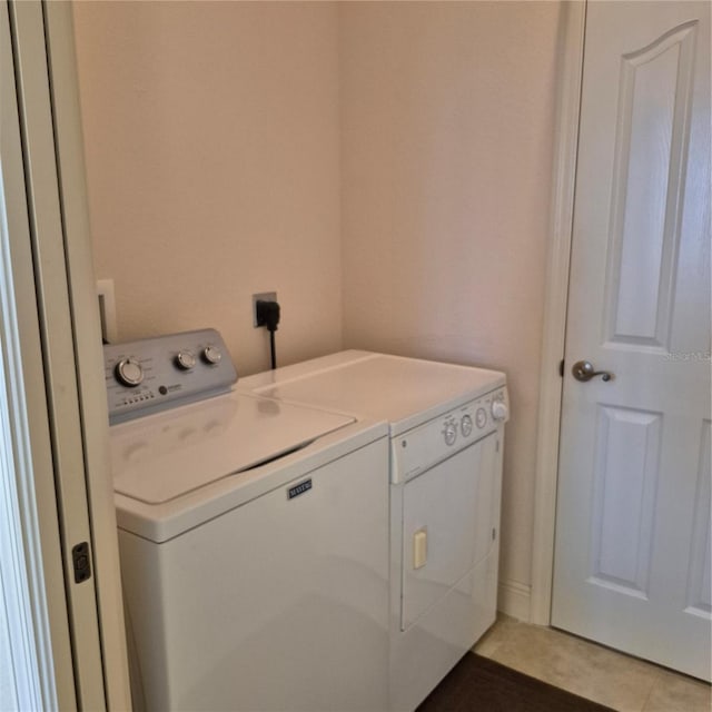 19 Medalist Way, Rotonda West, FL 33947 - washroom featuring separate washer and dryer and light tile patterned floors