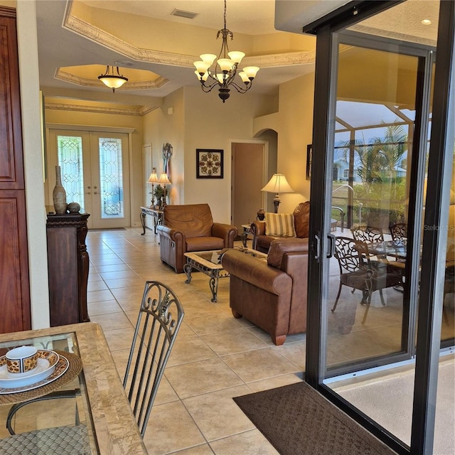 19 Medalist Way, Rotonda West, FL 33947 - living room featuring french doors, arched walkways, a chandelier, and light tile patterned floors