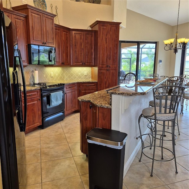 19 Medalist Way, Rotonda West, FL 33947 - kitchen featuring black appliances, decorative backsplash, light tile patterned floors, a breakfast bar, and lofted ceiling