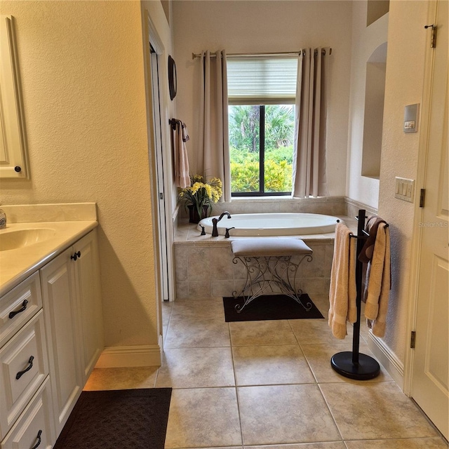 19 Medalist Way, Rotonda West, FL 33947 - full bath featuring vanity, a garden tub, tile patterned floors, and a textured wall
