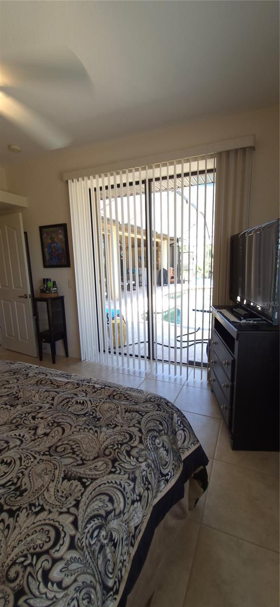 19 Medalist Way, Rotonda West, FL 33947 - bedroom featuring light tile patterned flooring and access to exterior