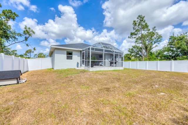 rear view of property featuring glass enclosure