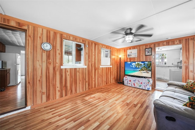 857 Palmetto St, Englewood, FL 34223 - living area featuring wood finished floors, wooden walls, and ceiling fan
