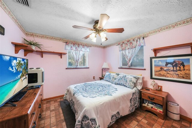 857 Palmetto St, Englewood, FL 34223 - bedroom with a textured ceiling, baseboards, and ceiling fan
