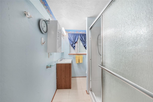 857 Palmetto St, Englewood, FL 34223 - full bath with a shower stall, tile patterned floors, a textured ceiling, and vanity