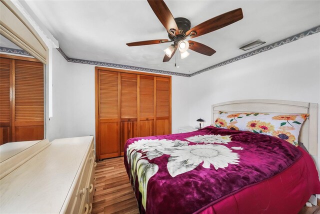 857 Palmetto St, Englewood, FL 34223 - bedroom featuring wood finished floors, a ceiling fan, and a closet