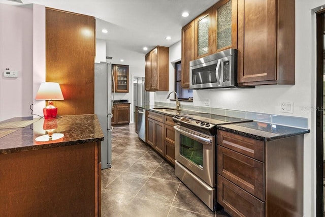 7180 Quarry St, Englewood, FL 34224 - kitchen with appliances with stainless steel finishes, a sink, recessed lighting, dark stone countertops, and dark tile patterned floors