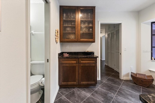 7180 Quarry St, Englewood, FL 34224 - bar featuring dark tile patterned flooring and baseboards