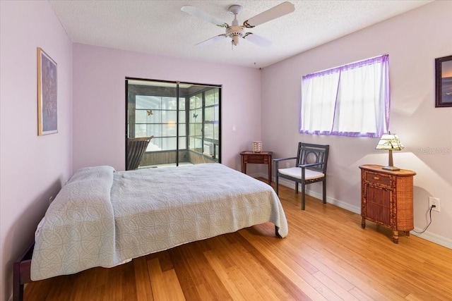 7180 Quarry St, Englewood, FL 34224 - bedroom featuring light wood finished floors, baseboards, a textured ceiling, and ceiling fan