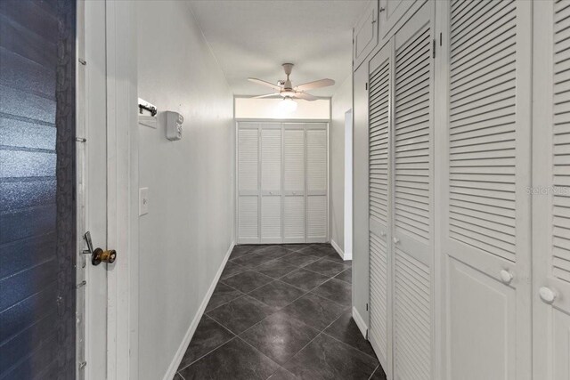 7180 Quarry St, Englewood, FL 34224 - hall featuring baseboards and dark tile patterned flooring