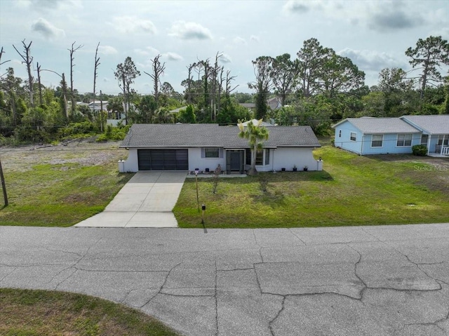 7180 Quarry St, Englewood, FL 34224 - ranch-style home with driveway, a garage, and a front yard