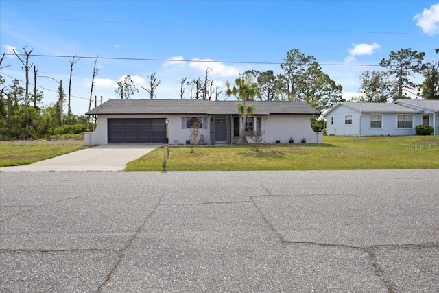 7180 Quarry St, Englewood, FL 34224 - ranch-style house featuring driveway, an attached garage, a front yard, and stucco siding