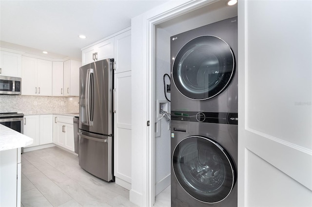 2700 N Beach Rd Unit A201, Englewood, FL 34223 - laundry area with stacked washer / drying machine and recessed lighting