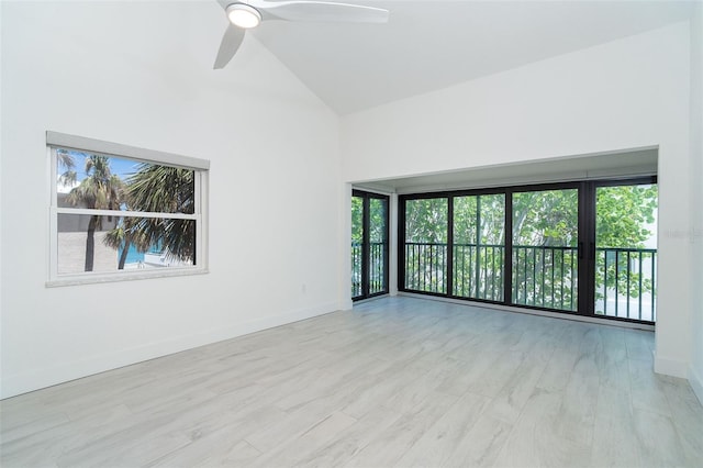 2700 N Beach Rd Unit A201, Englewood, FL 34223 - empty room with ceiling fan, baseboards, wood finished floors, and high vaulted ceiling