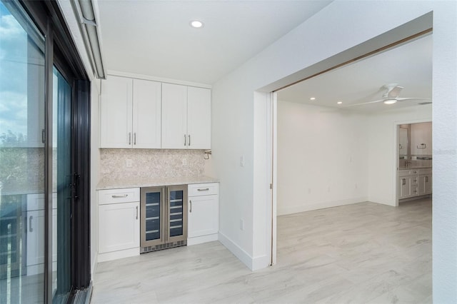 2700 N Beach Rd Unit A201, Englewood, FL 34223 - indoor dry bar featuring wine cooler, tasteful backsplash, ceiling fan, baseboards, and recessed lighting