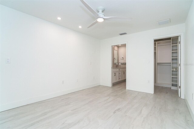 2700 N Beach Rd Unit A201, Englewood, FL 34223 - unfurnished bedroom with a spacious closet, baseboards, a closet, recessed lighting, and light wood finished floors