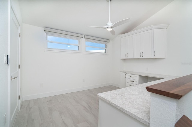 2700 N Beach Rd Unit A201, Englewood, FL 34223 - kitchen with light wood finished floors, white cabinets, lofted ceiling, ceiling fan, and light countertops