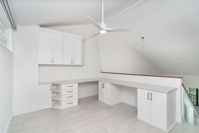 2700 N Beach Rd Unit A201, Englewood, FL 34223 - unfurnished office with vaulted ceiling, built in desk, a ceiling fan, light wood finished floors, and baseboards