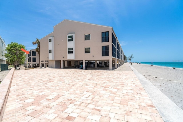 2700 N Beach Rd Unit A201, Englewood, FL 34223 - view of front of home with view of water and beach, a carport, and stucco siding