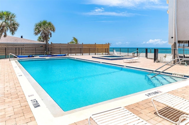 2700 N Beach Rd Unit A201, Englewood, FL 34223 - community pool featuring a hot tub, fence, a patio area, and a water view