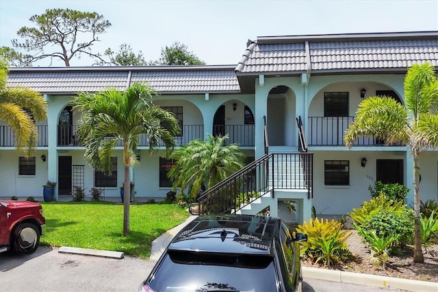 149 Englewood Isles Parkway Unit 603, Englewood, FL 34223 - view of property featuring stairs and uncovered parking
