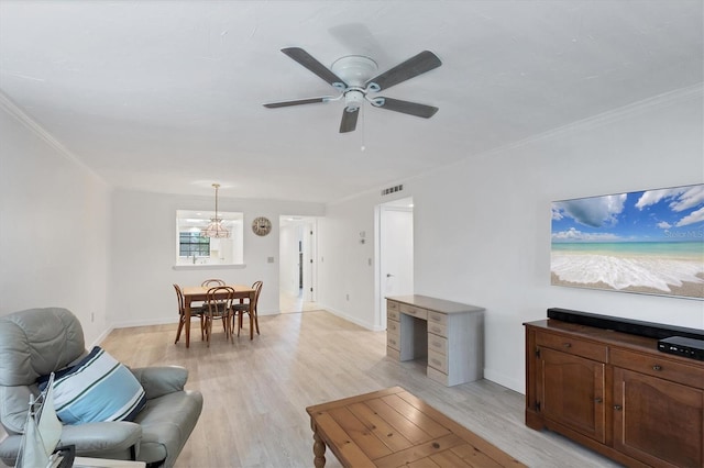 149 Englewood Isles Parkway Unit 603, Englewood, FL 34223 - living room featuring a chandelier, a ceiling fan, light wood-type flooring, crown molding, and baseboards