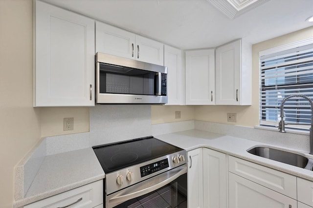 149 Englewood Isles Parkway Unit 603, Englewood, FL 34223 - kitchen featuring stainless steel appliances, a sink, white cabinets, and light countertops
