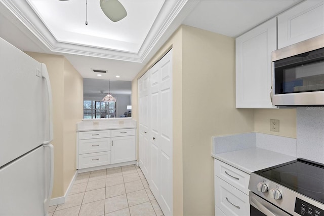 149 Englewood Isles Parkway Unit 603, Englewood, FL 34223 - kitchen featuring appliances with stainless steel finishes, light countertops, white cabinets, and light tile patterned floors
