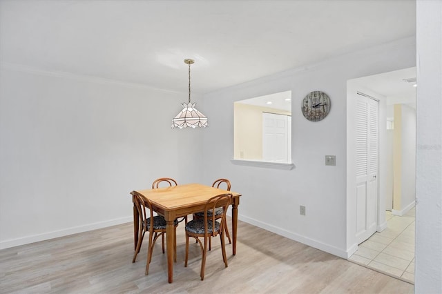 149 Englewood Isles Parkway Unit 603, Englewood, FL 34223 - dining area featuring ornamental molding, baseboards, and light wood-type flooring