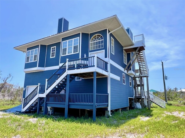 9594 Doubloon Trl, Placida, FL 33946 - rear view of property featuring stairs, a chimney, and a deck
