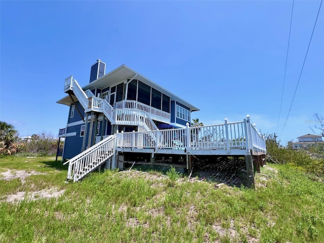 9594 Doubloon Trl, Placida, FL 33946 - rear view of property with a sunroom, stairway, a deck, and a chimney