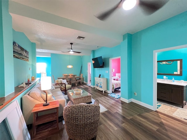 9594 Doubloon Trl, Placida, FL 33946 - living area featuring a ceiling fan, wood finished floors, and baseboards