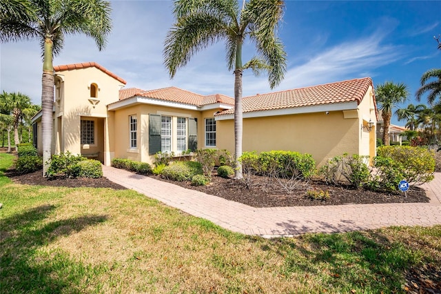 142 Savona Way N, Venice, FL 34275 - mediterranean / spanish-style house with a tile roof, stucco siding, and a front yard