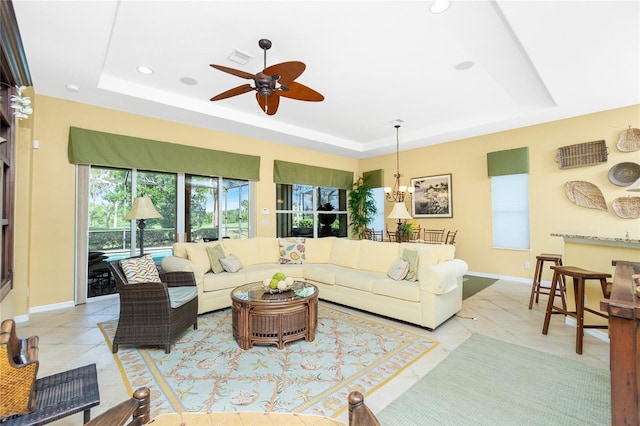 142 Savona Way N, Venice, FL 34275 - living room with a tray ceiling, ceiling fan, baseboards, and recessed lighting