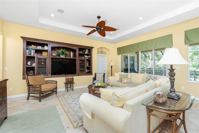142 Savona Way N, Venice, FL 34275 - living room with ceiling fan, recessed lighting, baseboards, and a tray ceiling