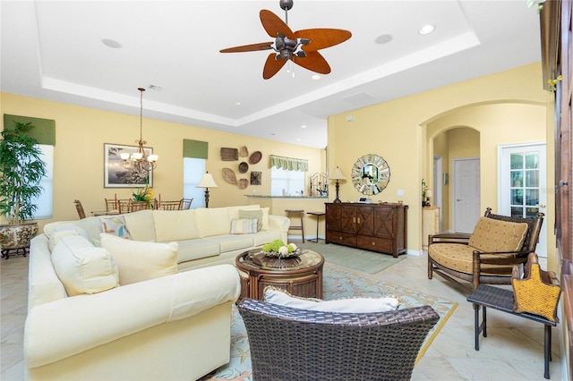 142 Savona Way N, Venice, FL 34275 - living room with a raised ceiling, arched walkways, ceiling fan, a chandelier, and recessed lighting