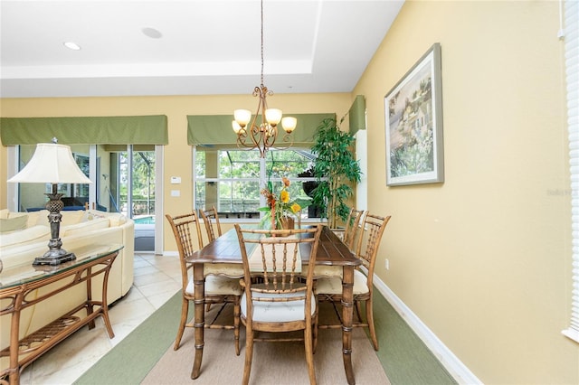 142 Savona Way N, Venice, FL 34275 - dining space featuring a chandelier, baseboards, and a tray ceiling
