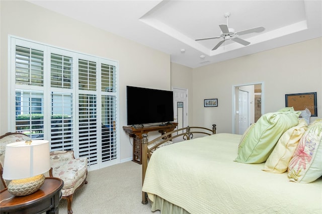 142 Savona Way N, Venice, FL 34275 - carpeted bedroom featuring a tray ceiling, ensuite bathroom, and ceiling fan