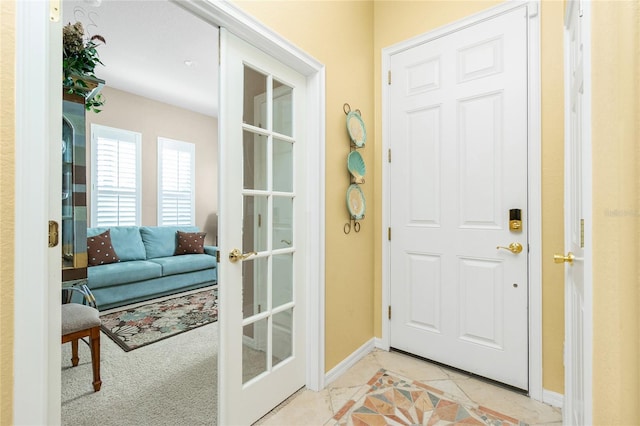 142 Savona Way N, Venice, FL 34275 - doorway with baseboards and light tile patterned flooring