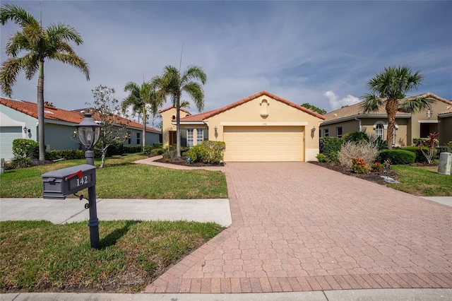 142 Savona Way N, Venice, FL 34275 - mediterranean / spanish house featuring a garage, decorative driveway, a front lawn, stucco siding, and a tiled roof