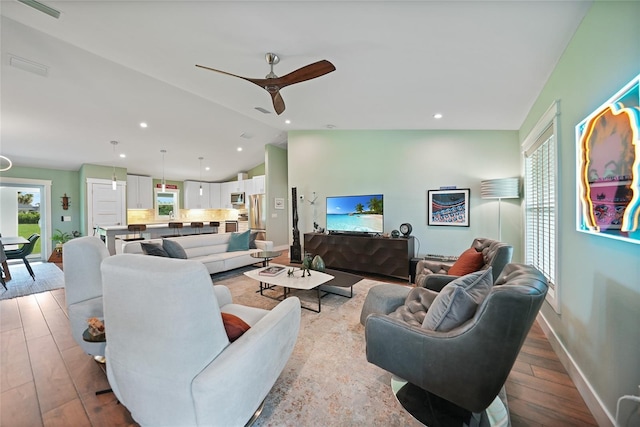 171 Mark Twain Ln, Rotonda West, FL 33947 - living room featuring lofted ceiling, wood finished floors, ceiling fan, baseboards, and recessed lighting
