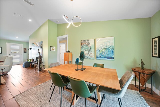 171 Mark Twain Ln, Rotonda West, FL 33947 - dining room featuring wood finished floors, lofted ceiling, baseboards, and recessed lighting