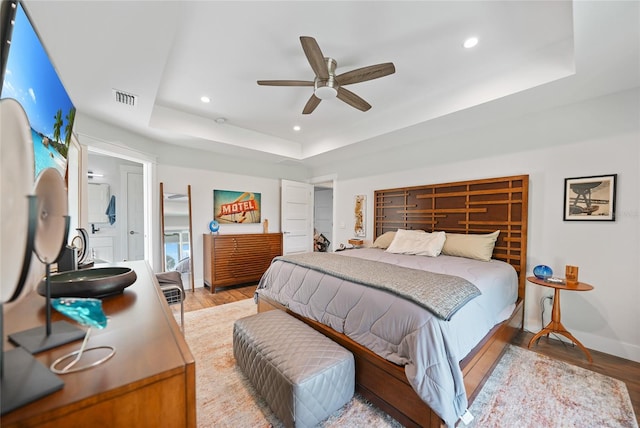 171 Mark Twain Ln, Rotonda West, FL 33947 - bedroom featuring a tray ceiling, light wood-style flooring, recessed lighting, baseboards, and a ceiling fan