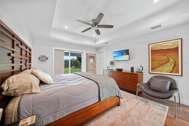 171 Mark Twain Ln, Rotonda West, FL 33947 - bedroom with recessed lighting, wood finished floors, a raised ceiling, ceiling fan, and baseboards
