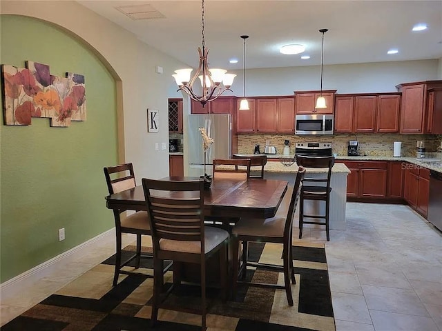 142 Yellow Pine Dr, Rotonda West, FL 33947 - dining space featuring recessed lighting, arched walkways, and a chandelier