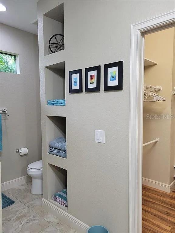 142 Yellow Pine Dr, Rotonda West, FL 33947 - bathroom with toilet and baseboards