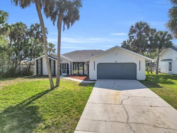 4210 Day St, Port Charlotte, FL 33948 - view of front of home with a garage, a front yard, driveway, and stucco siding
