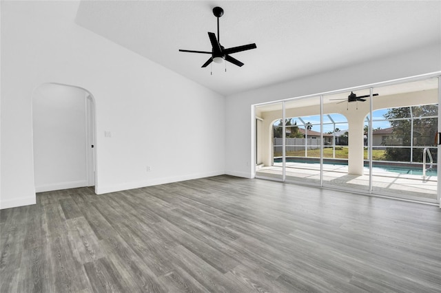 4210 Day St, Port Charlotte, FL 33948 - spare room featuring a ceiling fan, wood finished floors, arched walkways, vaulted ceiling, and baseboards