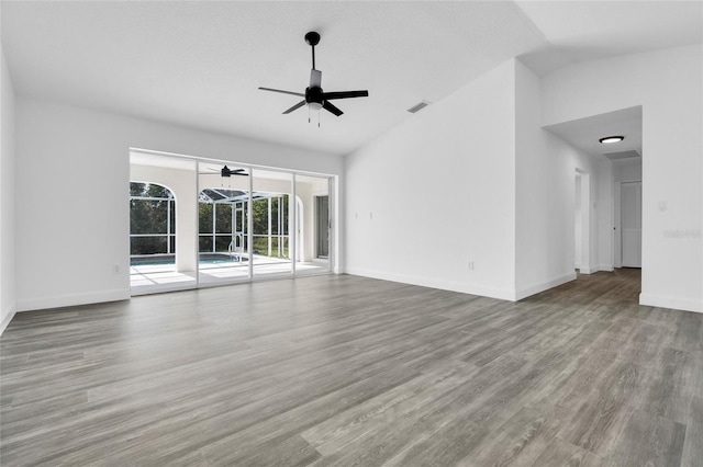 4210 Day St, Port Charlotte, FL 33948 - unfurnished living room featuring a ceiling fan, wood finished floors, lofted ceiling, and baseboards